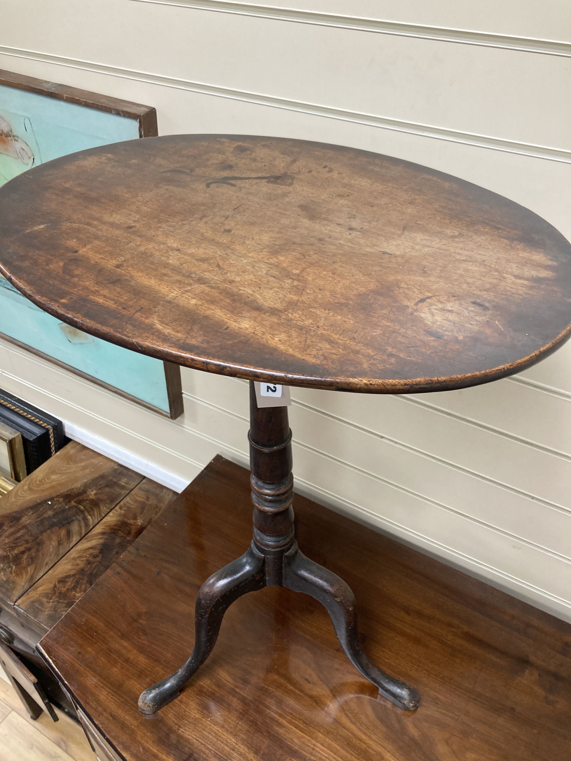 A 19th century mahogany oval tripod wine table, width 54cm, depth 40cm, height 70cm